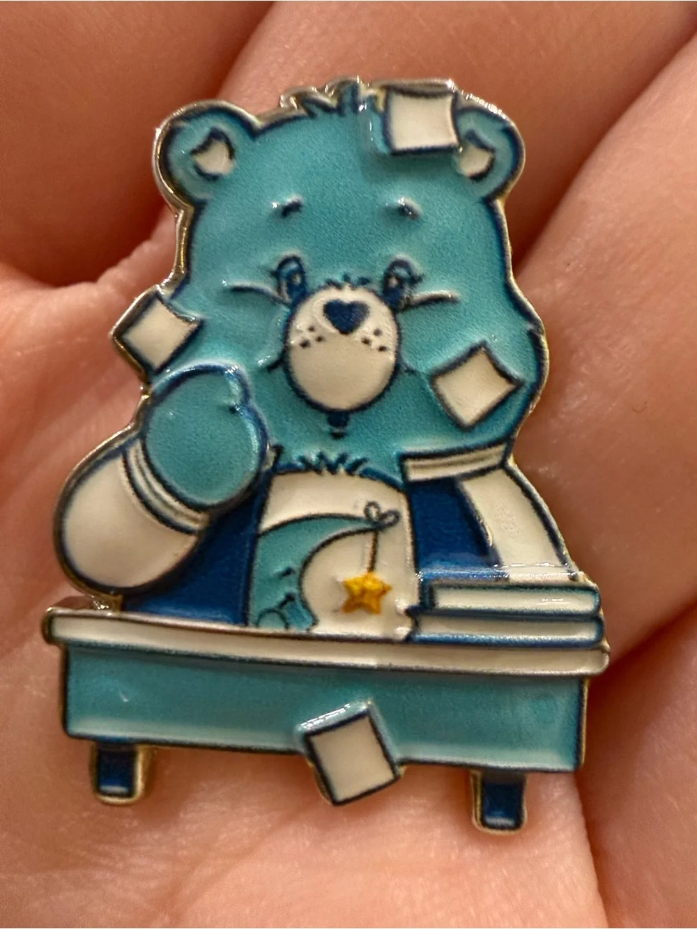 Care Bears Bedtime Bear sitting at desk—pin Blue Care Bear Enamel Pin